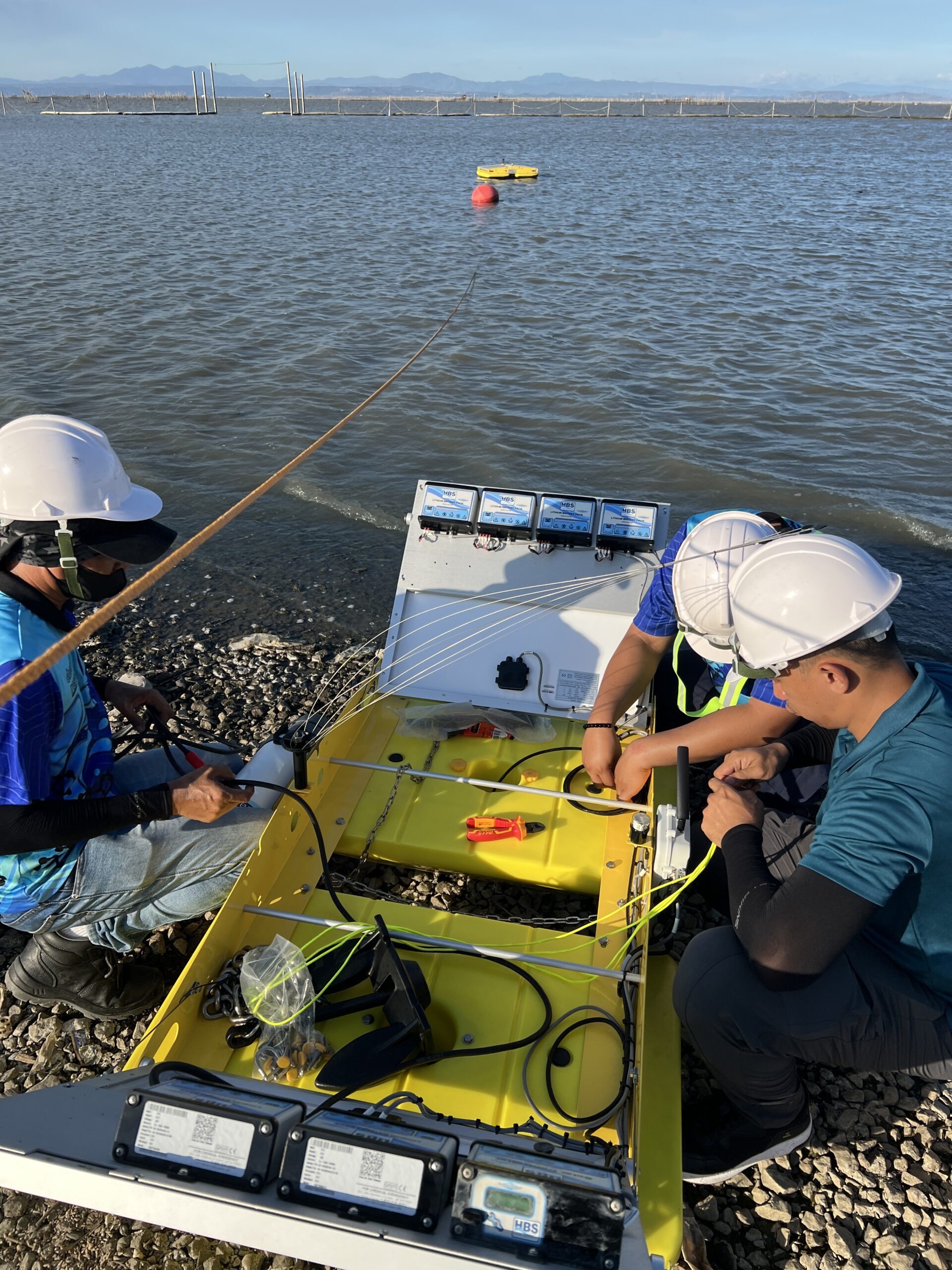 Workers preparing solaraft QDB for the water.
