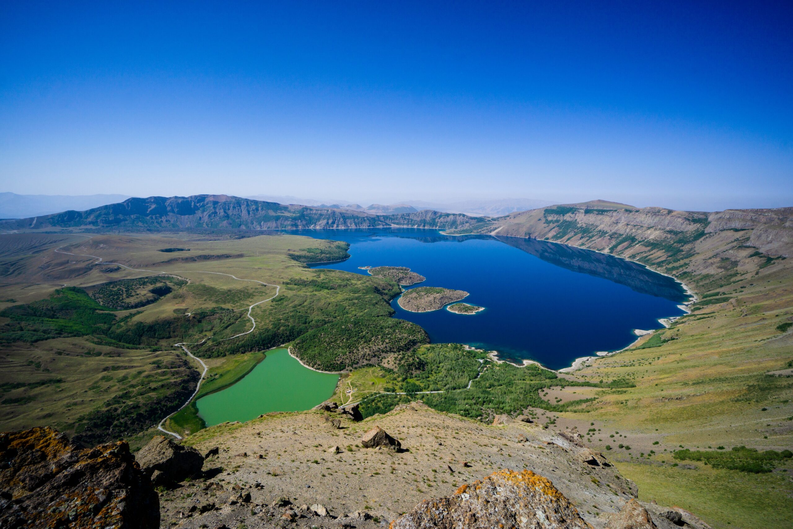 Large blue lake surround by green fields